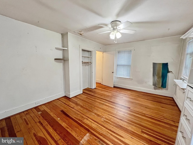 unfurnished bedroom featuring a closet, light hardwood / wood-style flooring, and ceiling fan