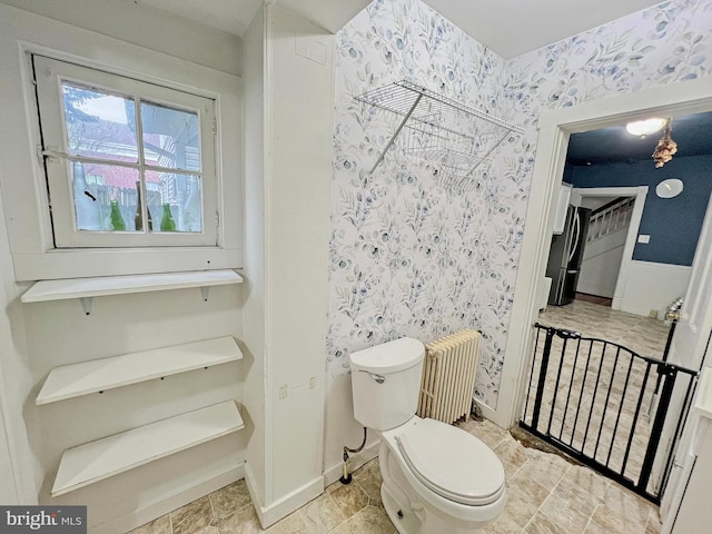 bathroom featuring toilet and radiator