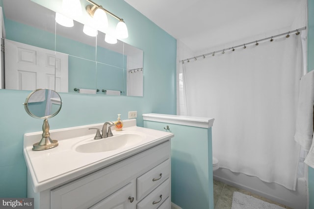 full bathroom with toilet, vanity, and shower / bath combo with shower curtain