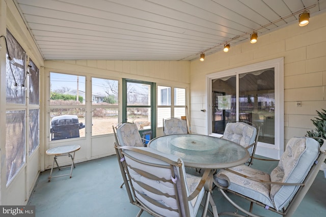 sunroom with lofted ceiling and plenty of natural light