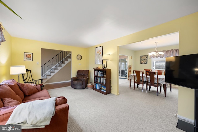 carpeted living room featuring an inviting chandelier