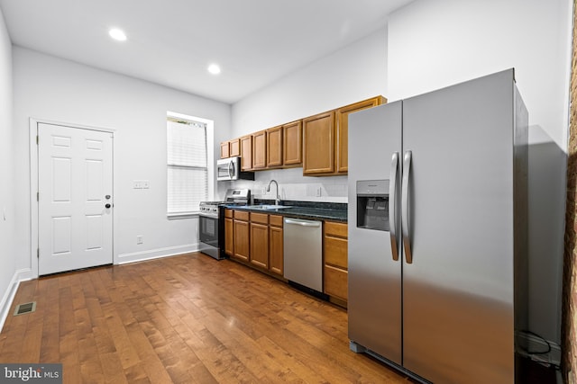 kitchen featuring sink, dark hardwood / wood-style flooring, and stainless steel appliances