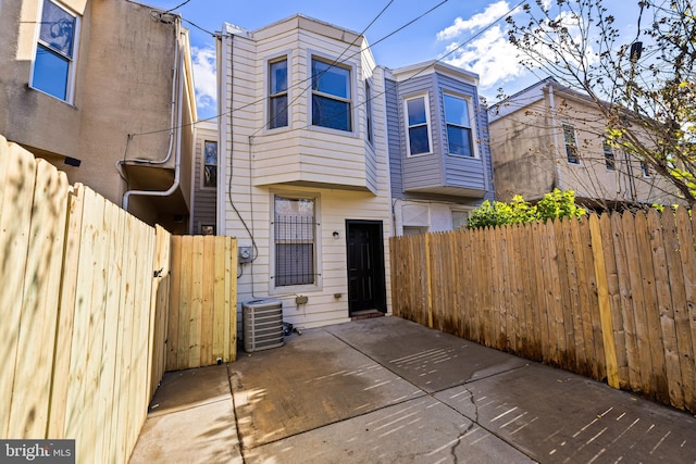 townhome / multi-family property featuring central AC and a patio