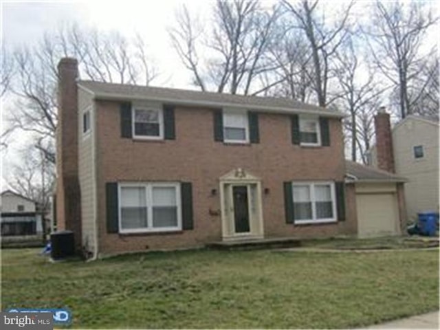 view of front facade with a front yard and a garage