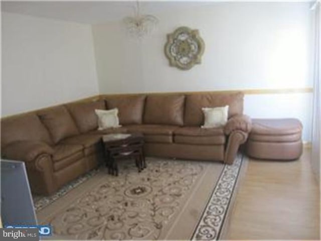 living room featuring light hardwood / wood-style flooring and a chandelier