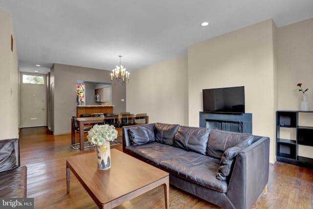 living room featuring hardwood / wood-style floors and a notable chandelier