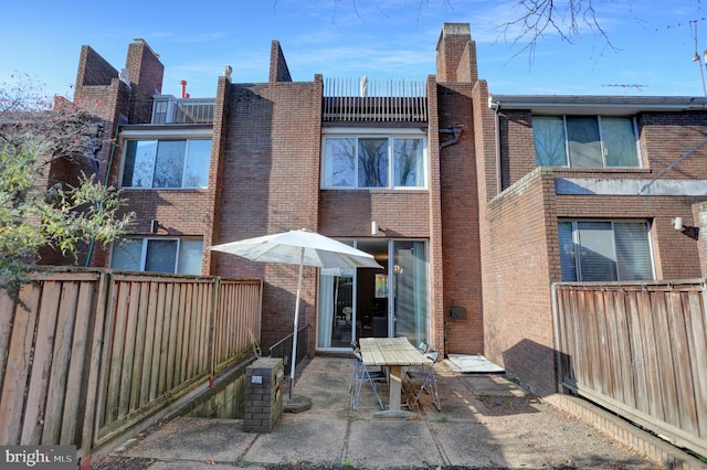 back of property featuring a patio area and a balcony