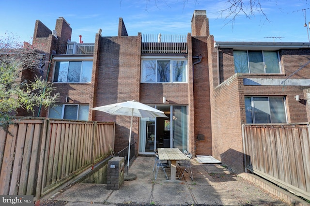 251 W Lafayette Ave, Baltimore, MD 21217 - back of house featuring a patio area, brick siding, and a fenced backyard