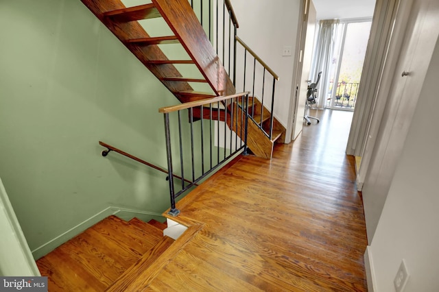 staircase featuring hardwood / wood-style floors