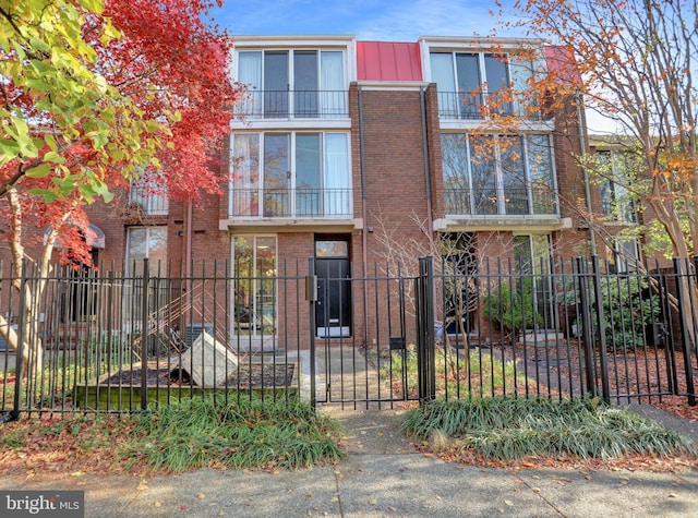 251 W Lafayette Ave, Baltimore, MD 21217 - view of front of home featuring a fenced front yard, brick siding, and a gate