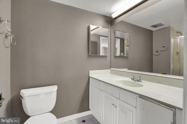 bathroom with toilet, vanity, tile patterned floors, and an enclosed shower