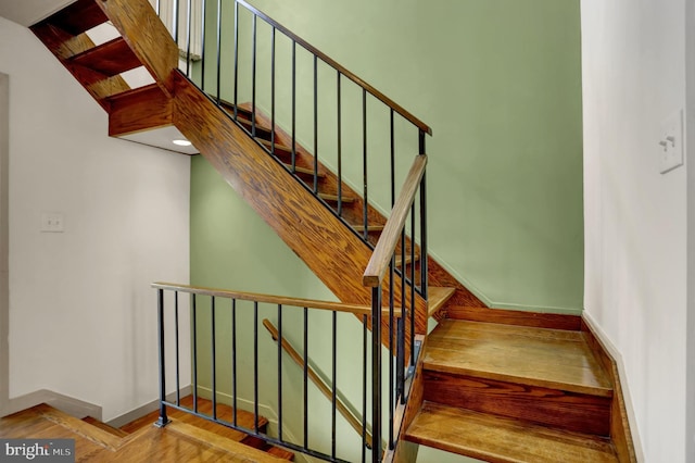 stairs featuring hardwood / wood-style floors