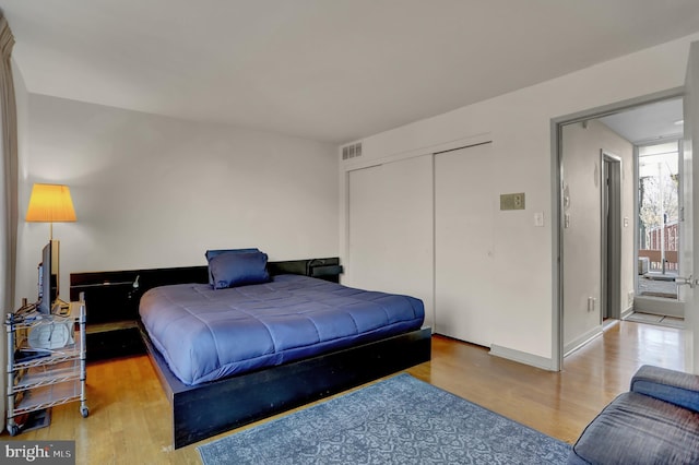 251 W Lafayette Ave, Baltimore, MD 21217 - bedroom featuring light wood-style floors, a closet, and baseboards