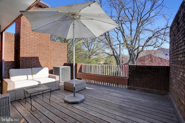 wooden terrace with an outdoor living space and central AC unit