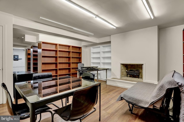 251 W Lafayette Ave, Baltimore, MD 21217 - dining area featuring light wood-style floors, a fireplace with raised hearth, and built in features
