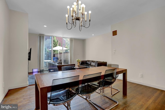 dining room featuring hardwood / wood-style floors and a chandelier