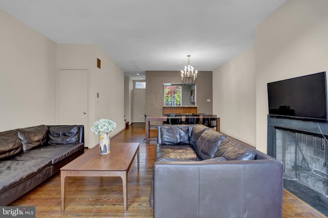 251 W Lafayette Ave, Baltimore, MD 21217 - living room featuring a chandelier, a fireplace, wood finished floors, and baseboards