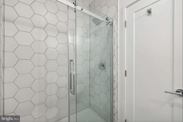 bathroom with a shower with shower door