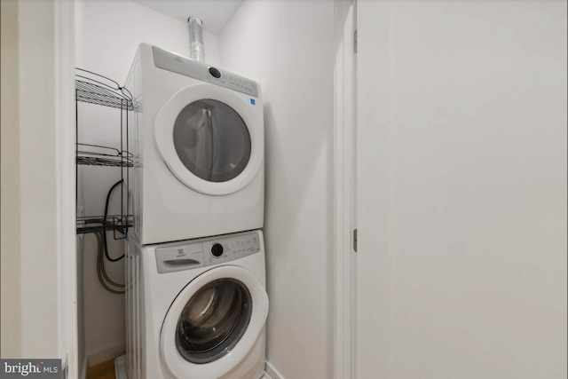 washroom featuring stacked washing maching and dryer