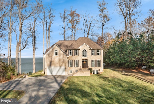 view of front of home with a garage, driveway, and a front yard