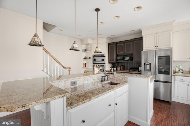 kitchen with dark wood-style floors, pendant lighting, open shelves, appliances with stainless steel finishes, and a sink