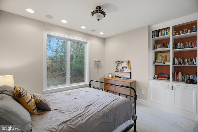 bedroom with baseboards, recessed lighting, and light colored carpet