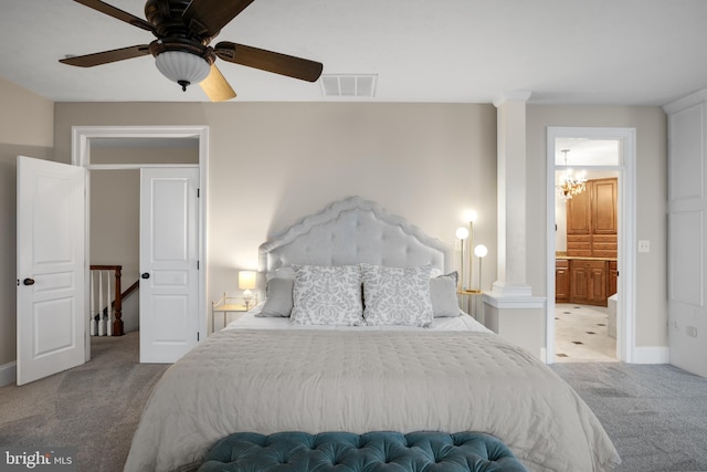 bedroom with decorative columns, visible vents, ceiling fan, ensuite bathroom, and carpet floors