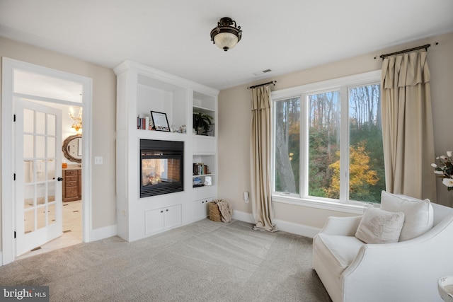 living area with baseboards, carpet flooring, and a multi sided fireplace