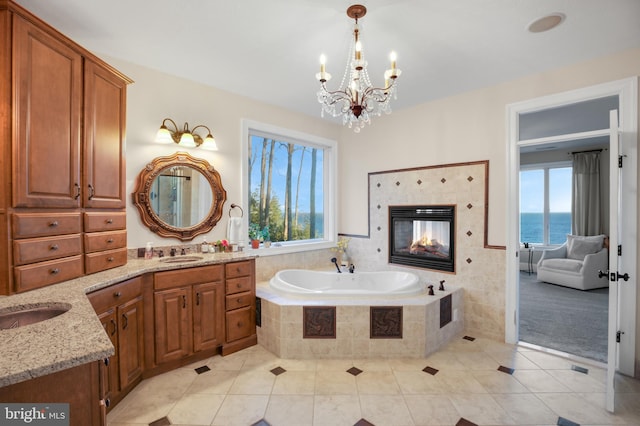 full bathroom featuring plenty of natural light, tiled bath, a fireplace, and tile patterned floors