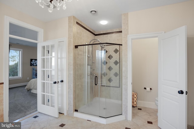 bathroom with visible vents, ensuite bathroom, a shower stall, tile patterned flooring, and baseboards