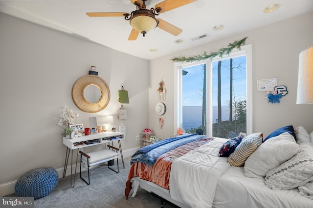 carpeted bedroom featuring baseboards, visible vents, and ceiling fan