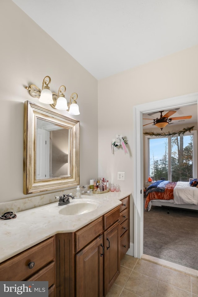 ensuite bathroom with tile patterned flooring, connected bathroom, and vanity