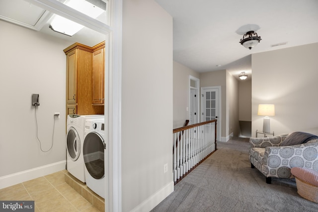 laundry area featuring light tile patterned floors, cabinet space, visible vents, washer and dryer, and baseboards