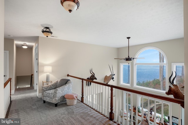 sitting room with carpet and a ceiling fan