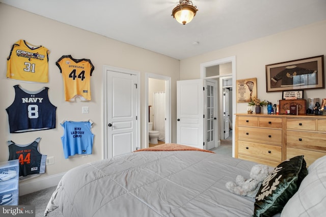 bedroom with carpet, connected bathroom, and baseboards