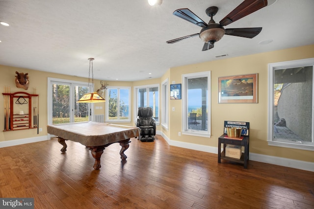 rec room featuring hardwood / wood-style floors, visible vents, and baseboards