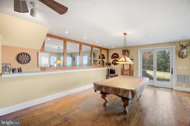 recreation room with recessed lighting, visible vents, baseboards, and hardwood / wood-style flooring