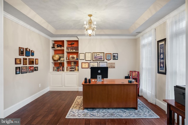 office space featuring dark wood-style floors, a raised ceiling, a notable chandelier, and baseboards