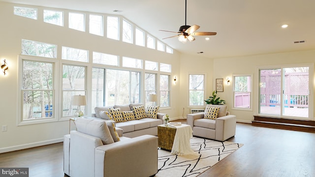 living room featuring light wood-type flooring, high vaulted ceiling, and ceiling fan