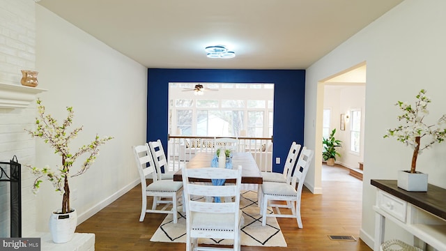 dining room with hardwood / wood-style floors, ceiling fan, and a healthy amount of sunlight