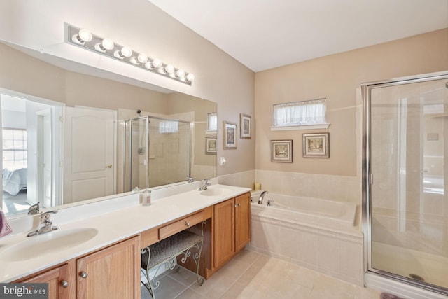 bathroom with tile patterned floors, vanity, and shower with separate bathtub