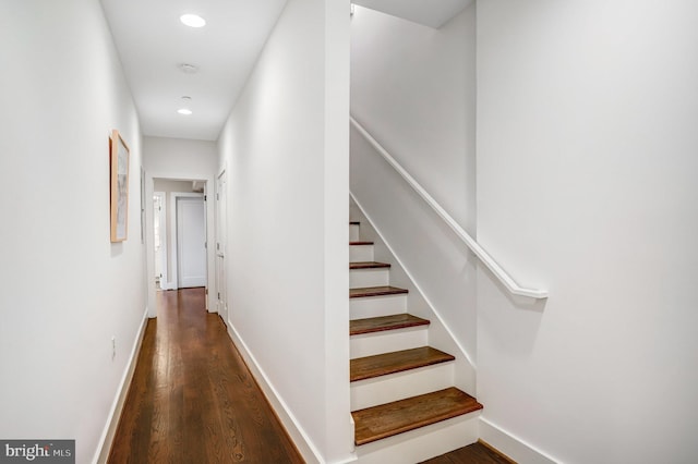 hall with stairway, baseboards, dark wood-type flooring, and recessed lighting