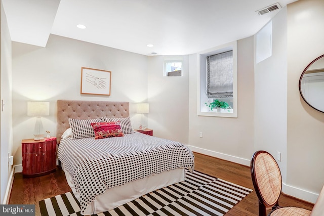 bedroom with recessed lighting, wood finished floors, visible vents, and baseboards