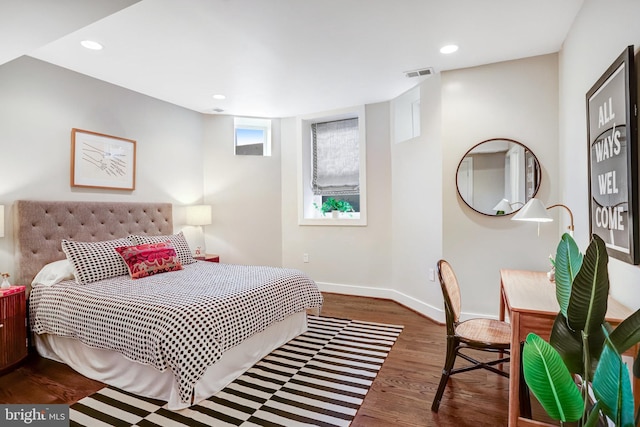 bedroom with baseboards, visible vents, dark wood-type flooring, and recessed lighting