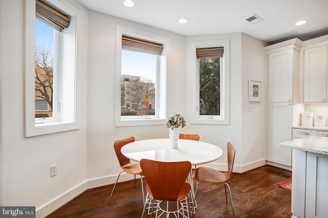 dining area with recessed lighting, dark wood finished floors, visible vents, and baseboards