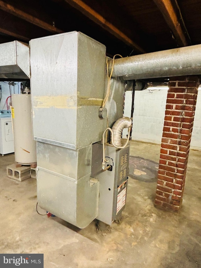 utilities featuring heating unit, gas water heater, and washer / dryer