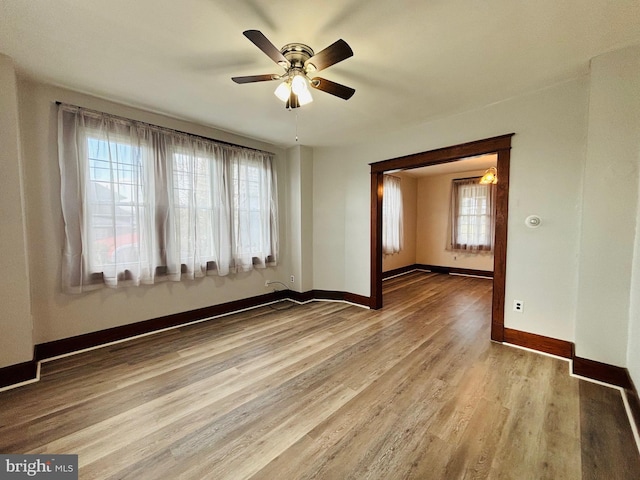 spare room with hardwood / wood-style floors and ceiling fan