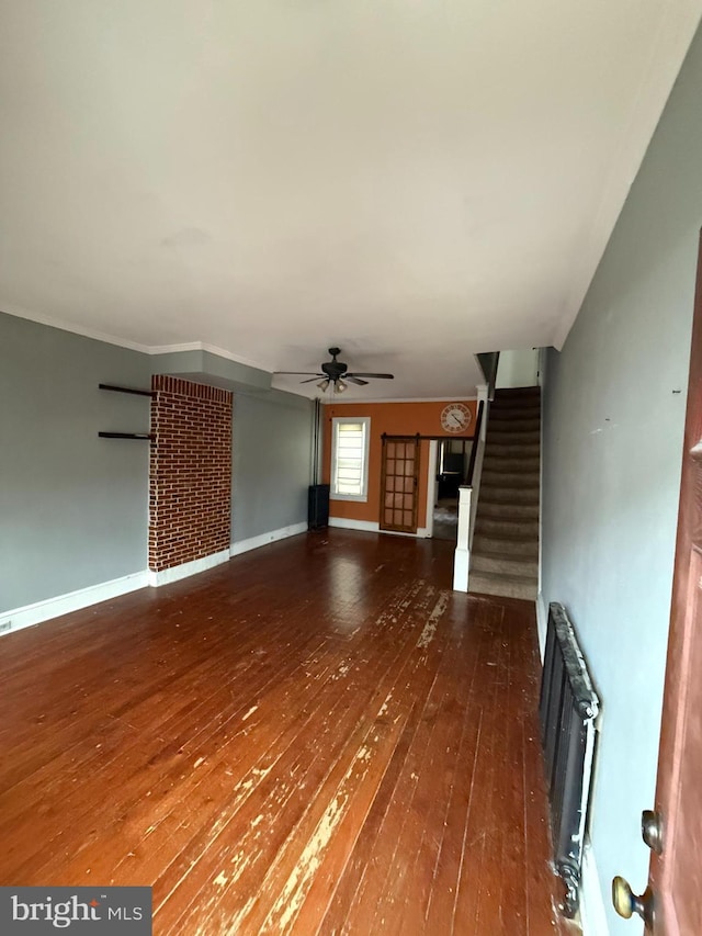 unfurnished living room featuring radiator, ceiling fan, and dark wood-type flooring