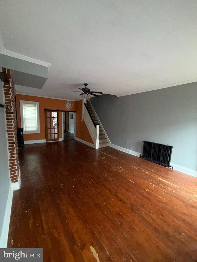 unfurnished living room featuring ceiling fan and dark wood-type flooring