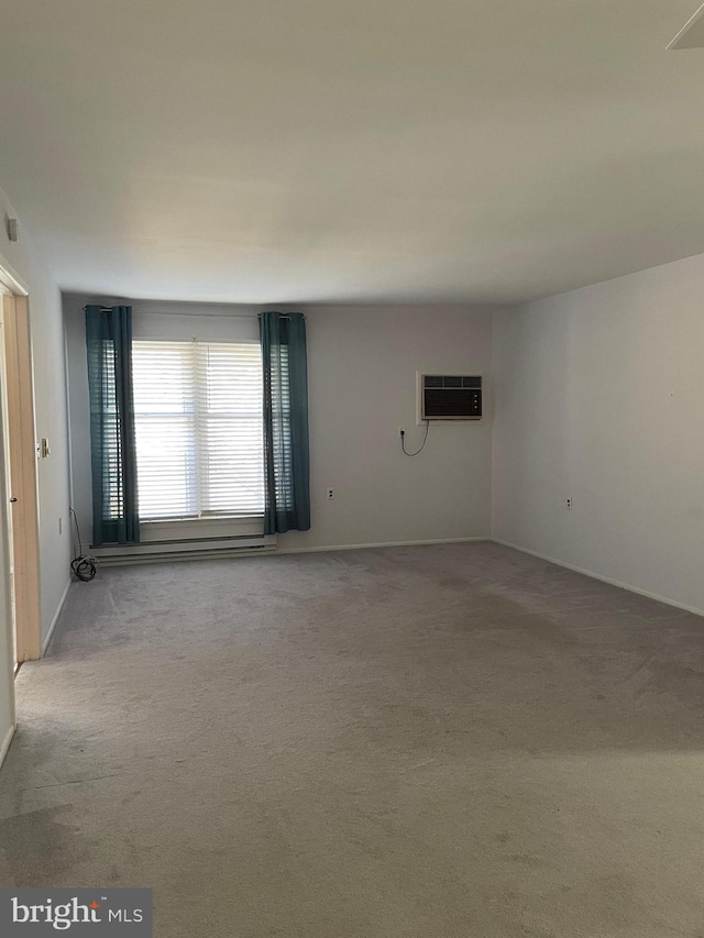 carpeted spare room with a wall mounted air conditioner